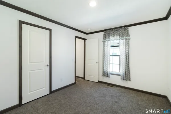 an empty room with windows and closet