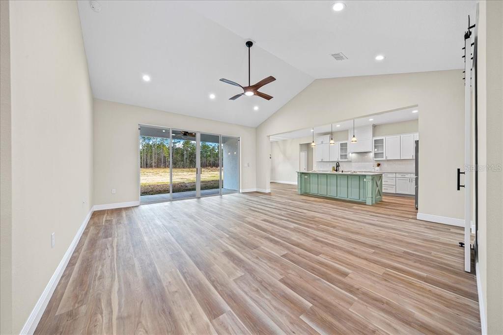 5315 Southwest 121st Terrace Ocala, FL 34481 - Photo 16 of 56 a view of empty room with wooden floor and windows