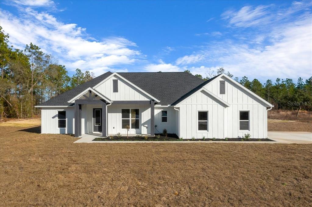 5315 Southwest 121st Terrace Ocala, FL 34481 - Photo 2 of 56 a front view of a house with a yard and garage