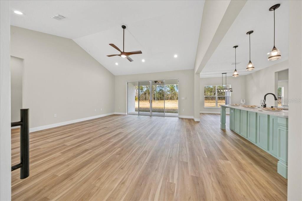 5315 Southwest 121st Terrace Ocala, FL 34481 - Photo 28 of 56 a view of a room with wooden floor windows and a ceiling fan