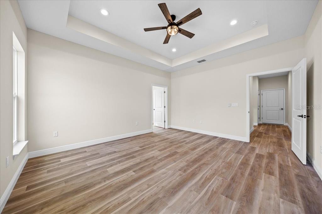 5315 Southwest 121st Terrace Ocala, FL 34481 - Photo 33 of 56 an empty room with wooden floor and a ceiling fan
