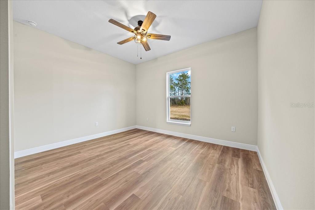 5315 Southwest 121st Terrace Ocala, FL 34481 - Photo 45 of 56 an empty room with a window and wooden floor