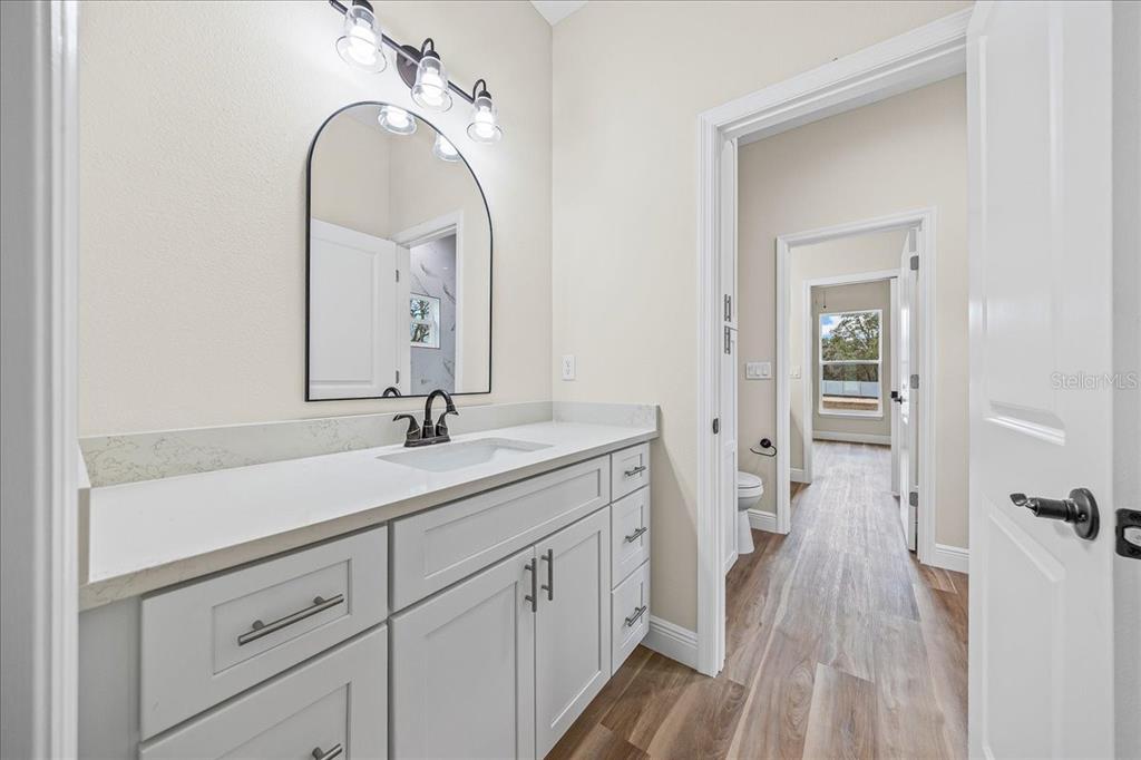 5315 Southwest 121st Terrace Ocala, FL 34481 - Photo 49 of 56 a en suite bathroom with a double vanity sink and a mirror