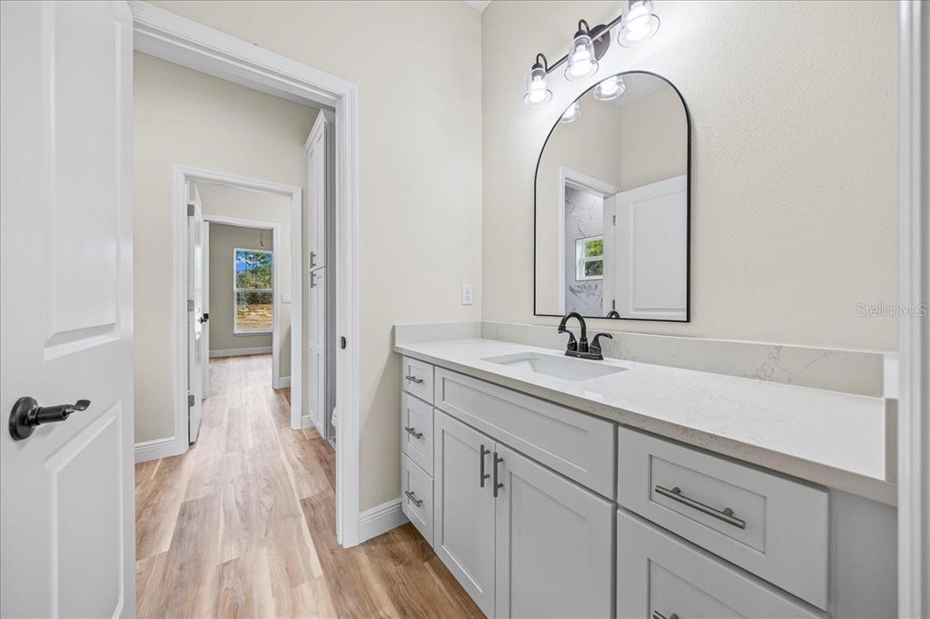 5315 Southwest 121st Terrace Ocala, FL 34481 - Photo 50 of 56 a en suite bathroom with a double vanity sink and a mirror