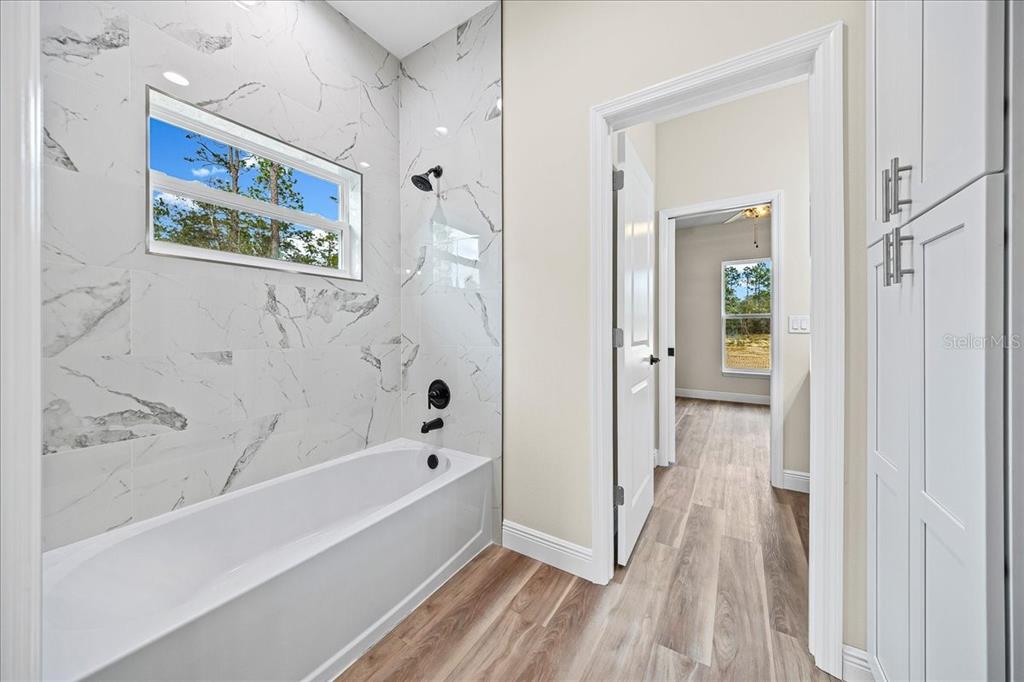 5315 Southwest 121st Terrace Ocala, FL 34481 - Photo 51 of 56 a bathroom with bathtub and a shower