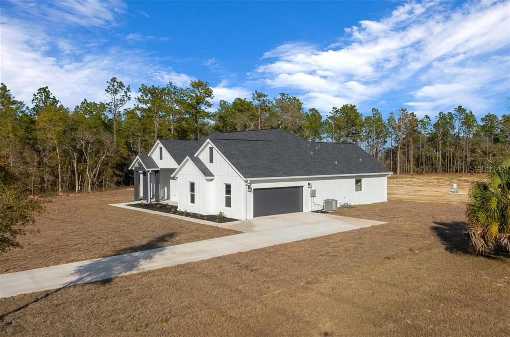 5315 Southwest 121st Terrace Ocala, FL 34481 - Photo 6 of 56 front view of a house with a yard