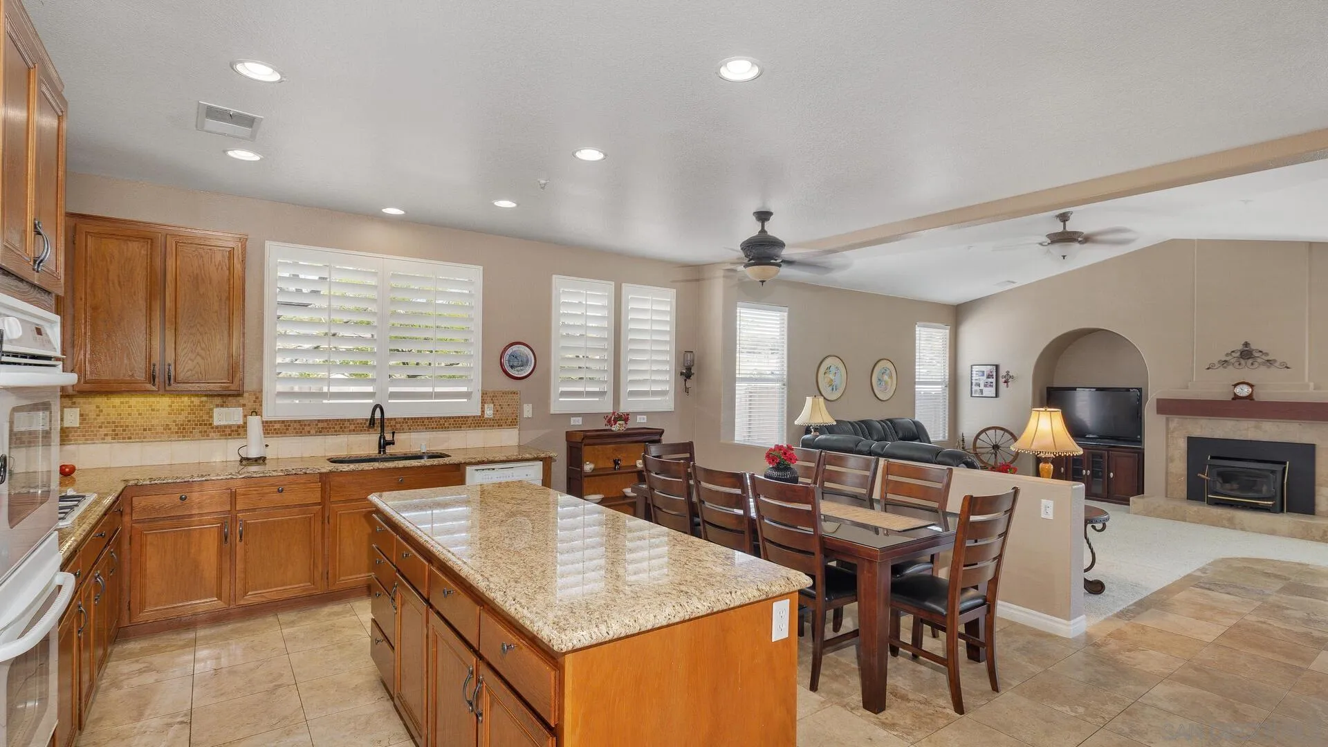 17435 Rising Dale Way Ramona, CA 92065 - Photo 5 of 24 a kitchen with a stove a sink a counter top space and living room