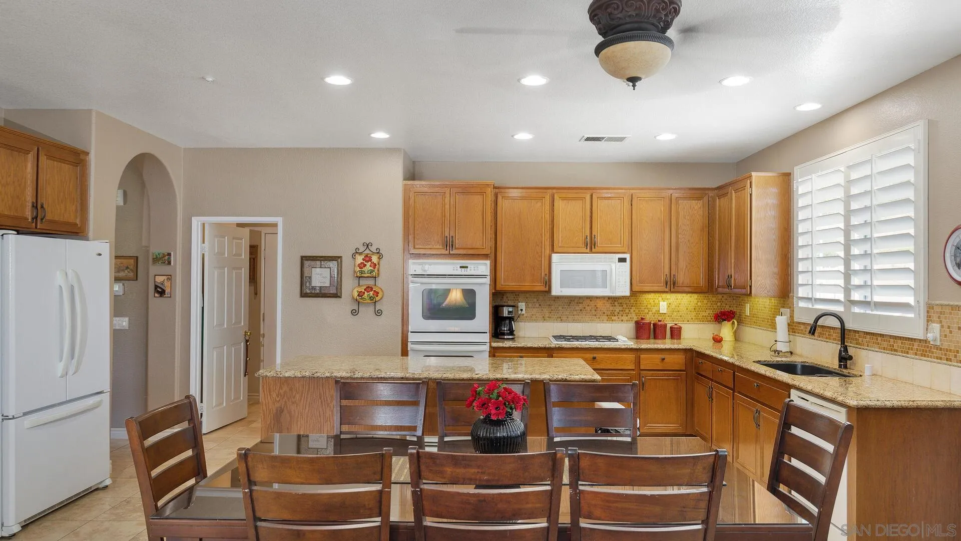 17435 Rising Dale Way Ramona, CA 92065 - Photo 8 of 24 a kitchen with stainless steel appliances granite countertop a sink stove and refrigerator