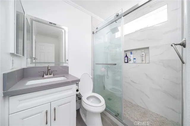 a bathroom with a sink toilet and a mirror