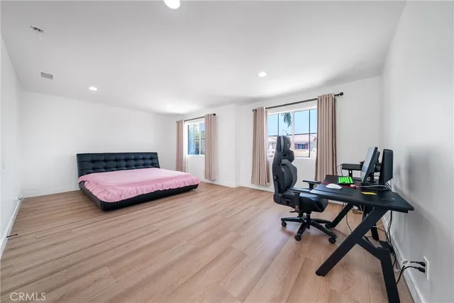 a bedroom with a bed lamp and a window