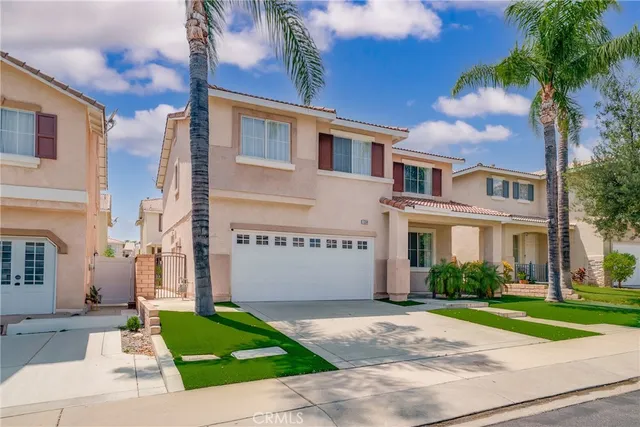 a front view of a house with a garden and plants
