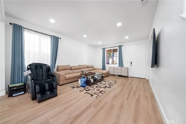 a living room with furniture and wooden floor