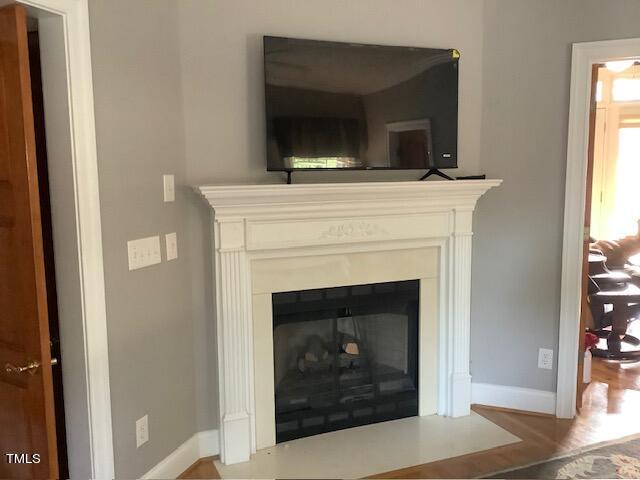 2125 Keith Hills Road Lillington, NC 27546 - Photo 31 of 66 a living room with a fireplace and a flat screen tv