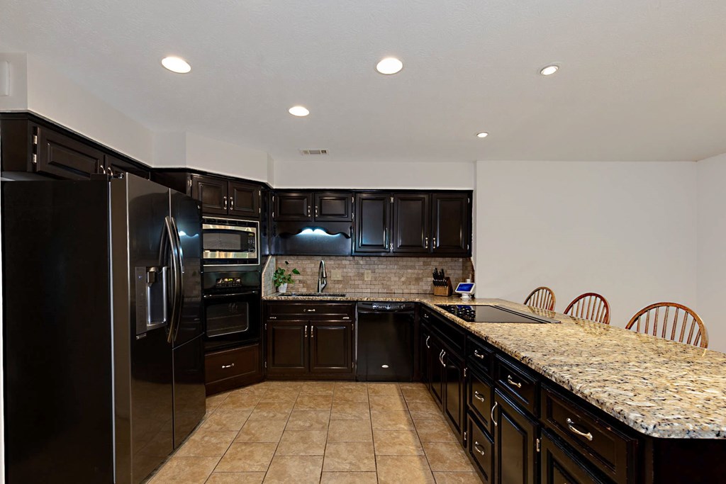 2495 Fortson Road Fortson, GA 31808 - Photo 9 of 30 a kitchen with granite countertop a sink stainless steel appliances and cabinets