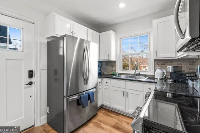 a kitchen with stainless steel appliances a refrigerator sink and stove