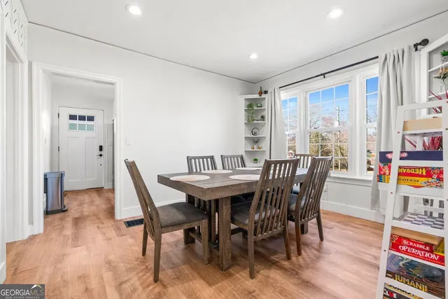 a view of a dining room with furniture window and wooden floor