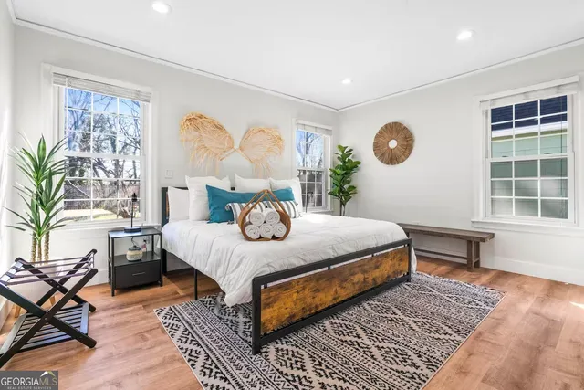 a bedroom with a large bed and a window with outer view