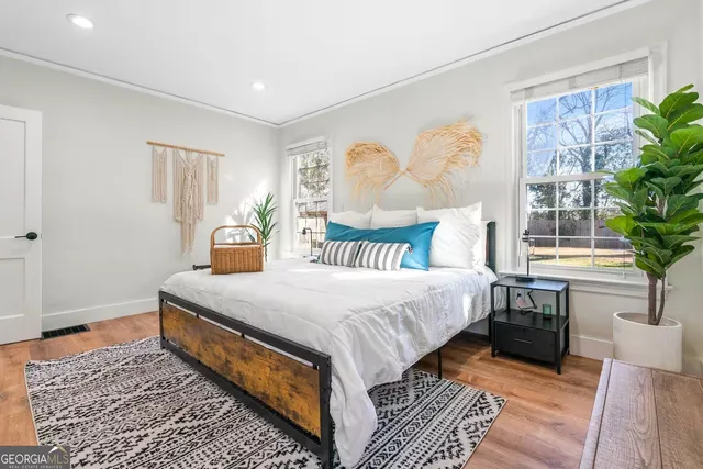 a bedroom with a large bed and a window