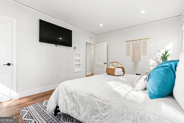 a bedroom with a bed and a flat screen tv