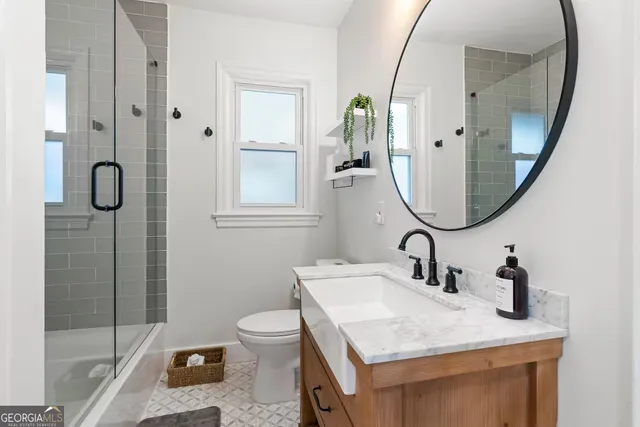 a bathroom with a sink vanity granite and a mirror