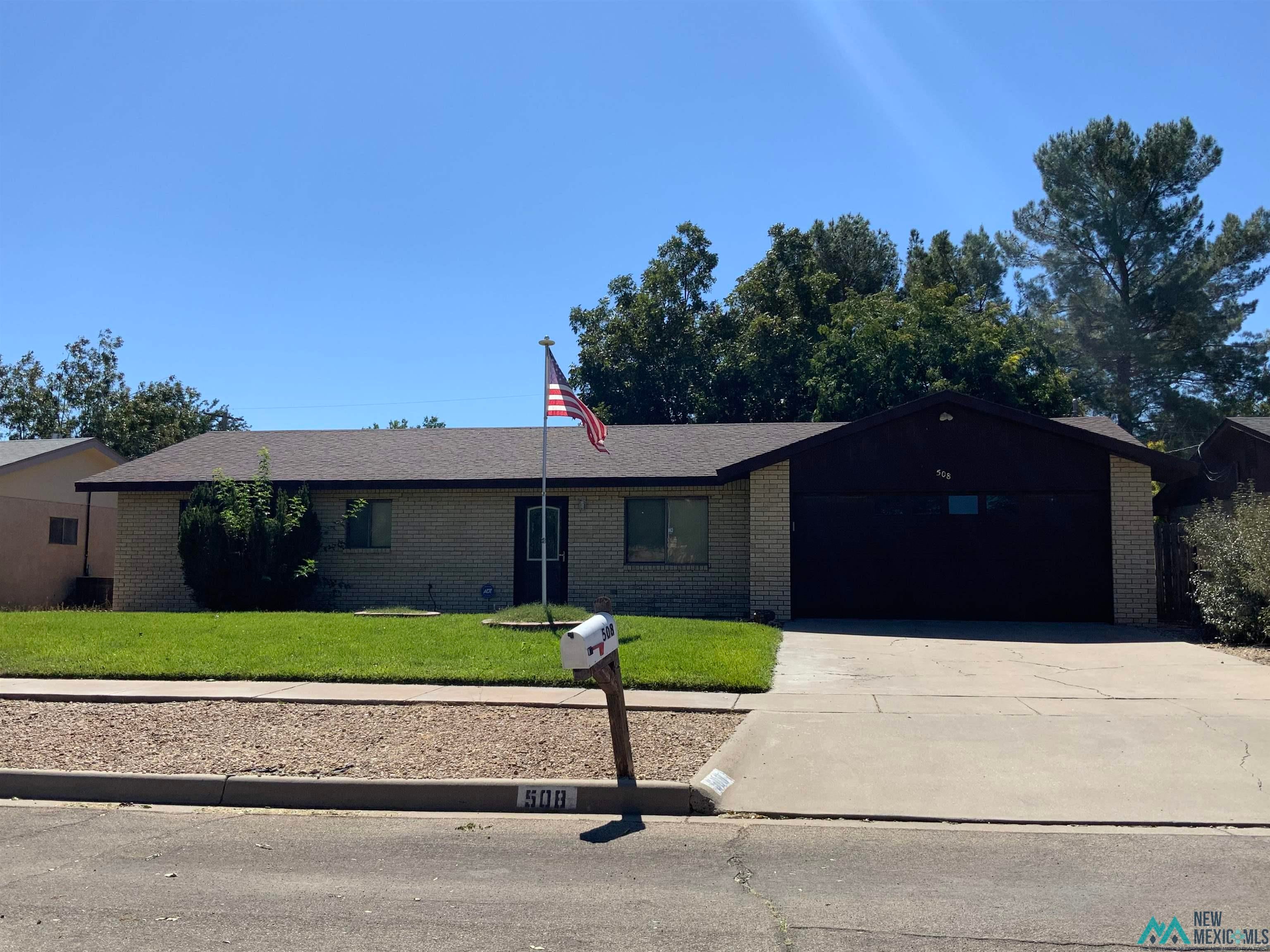 508 Sunrise Road Roswell, NM 88201 - Photo 1 of 1 Single story home featuring a front yard, brick siding, driveway, and an attached garage
