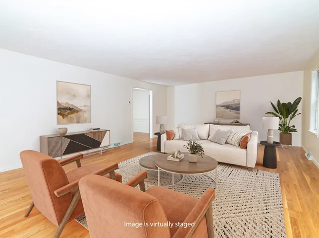 a living room with furniture a rug and a table