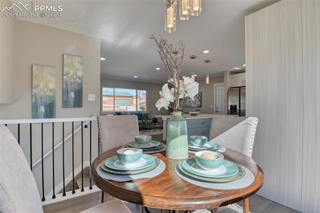 1913 Wooten Road Colorado Springs, CO 80915 - Photo 27 of 50 Dining area featuring a chandelier and light hardwood / wood-style floors