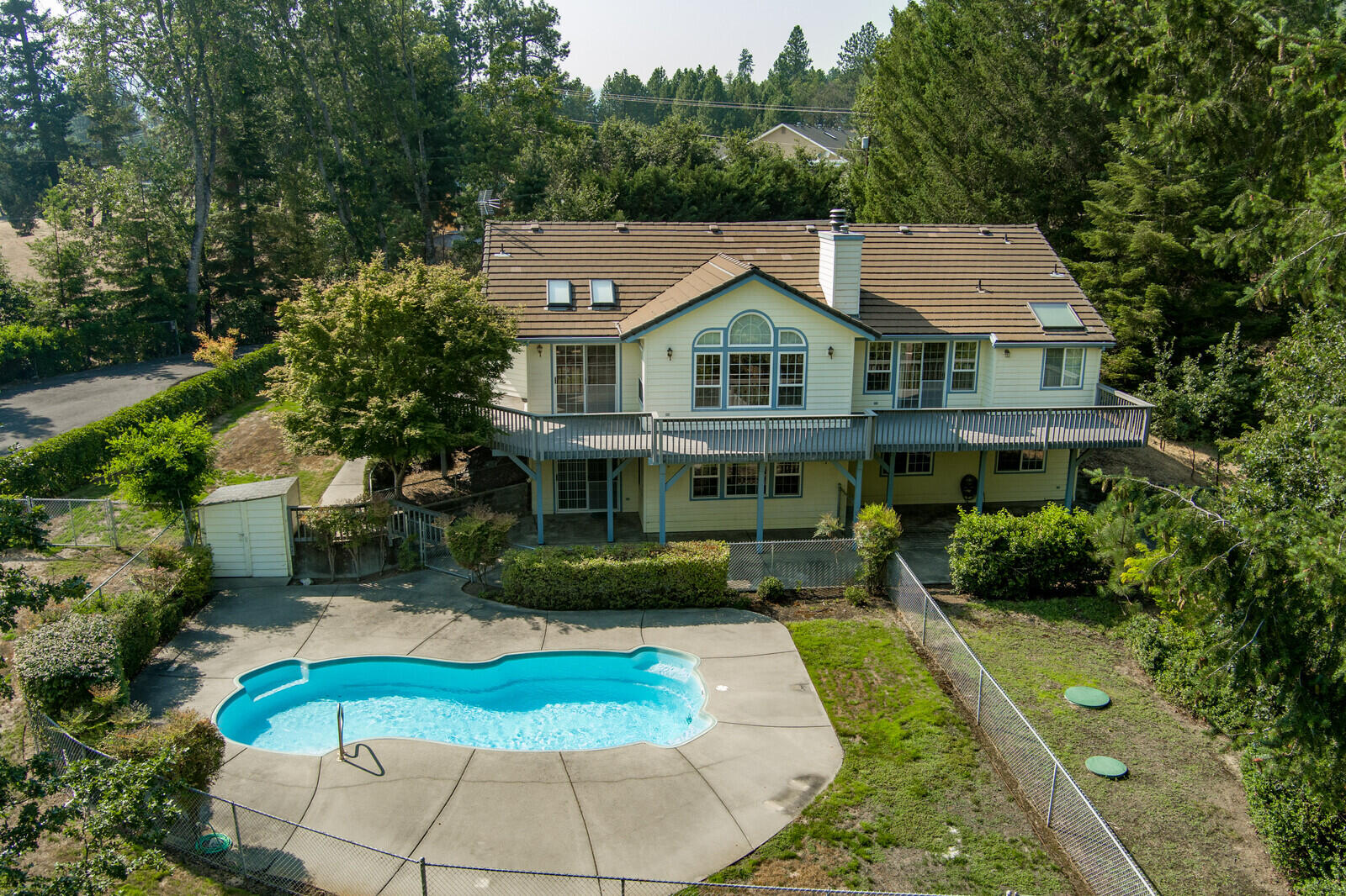 7212 Lower River Road Grants Pass, OR 97526 - Photo 14 of 31 a aerial view of a house with a yard table and chairs