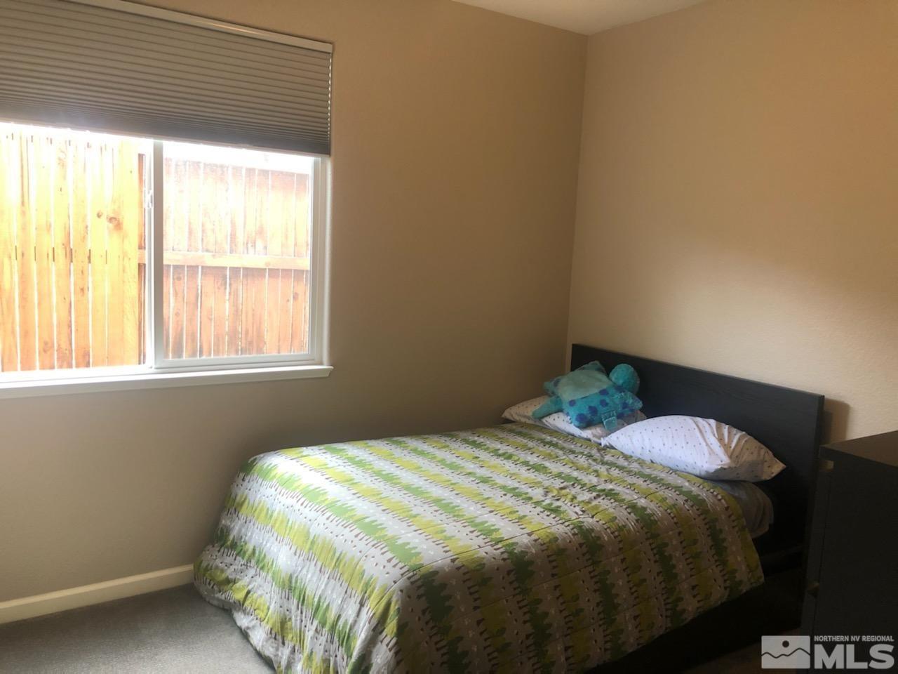 1707 River Gorge Court Reno, NV 89521 - Photo 8 of 18 a bedroom with a bed and a window