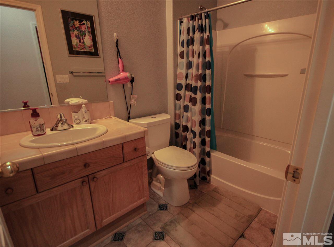 1707 River Gorge Court Reno, NV 89521 - Photo 10 of 18 a bathroom with a sink a toilet and shower