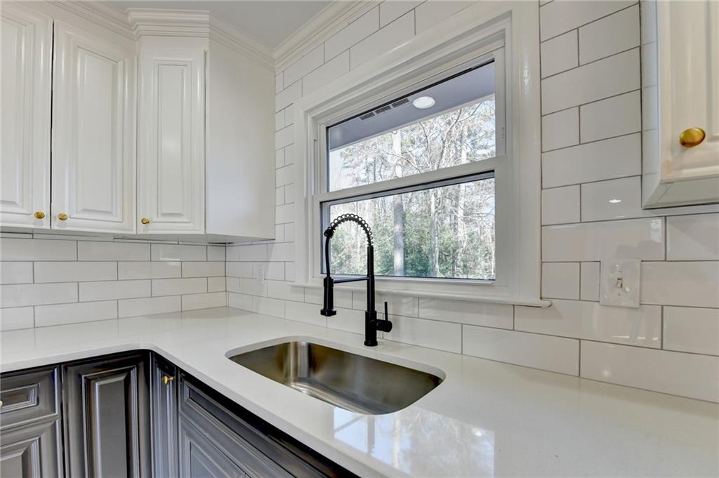 3463 Northlake Way Atlanta, GA 30340 - Photo 16 of 73 a kitchen with granite countertop a sink and a window