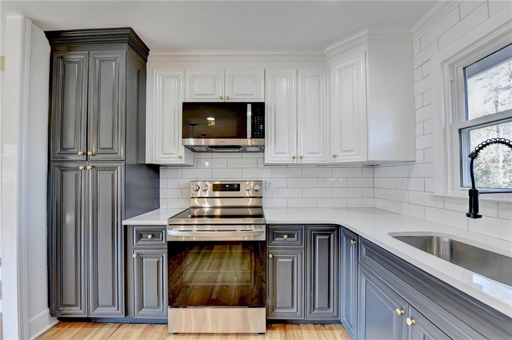 3463 Northlake Way Atlanta, GA 30340 - Photo 17 of 73 a kitchen with stainless steel appliances a stove microwave and sink