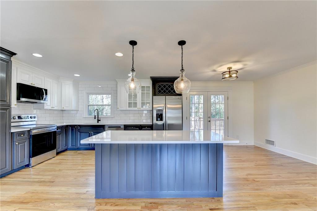 3463 Northlake Way Atlanta, GA 30340 - Photo 20 of 73 a kitchen with stainless steel appliances granite countertop wooden floors and sink