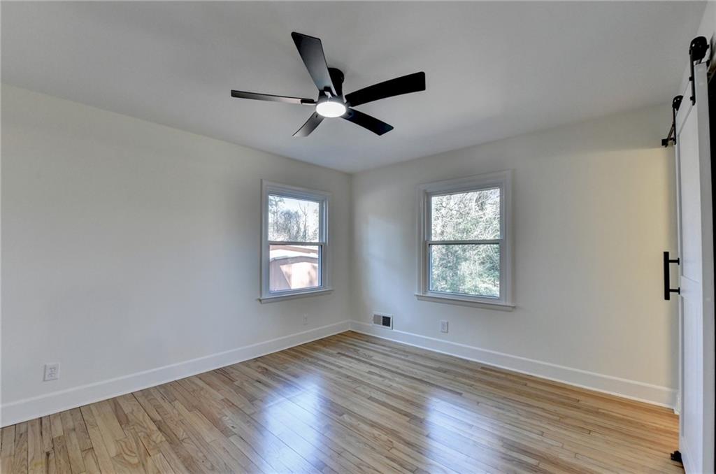 3463 Northlake Way Atlanta, GA 30340 - Photo 29 of 73 a view of an empty room with wooden floor and a window