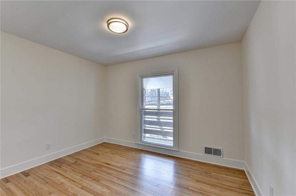 3463 Northlake Way Atlanta, GA 30340 - Photo 42 of 73 a view of an empty room with wooden floor and a window