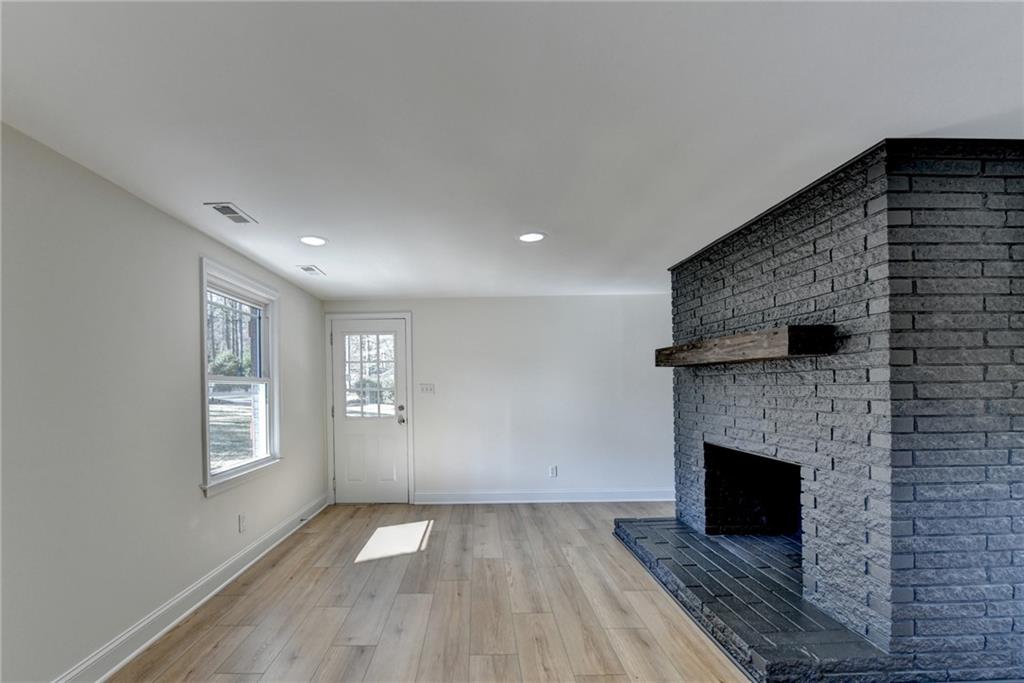 3463 Northlake Way Atlanta, GA 30340 - Photo 46 of 73 a view of an empty room with wooden floor fireplace and a window