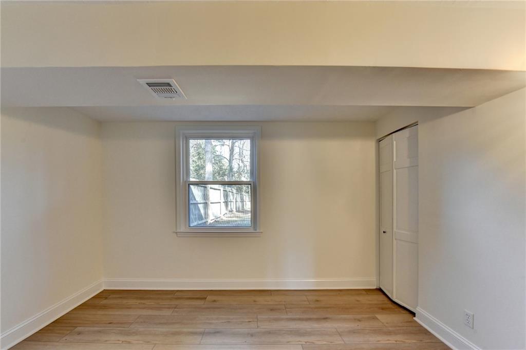 3463 Northlake Way Atlanta, GA 30340 - Photo 52 of 73 a view of an empty room with wooden floor and a window