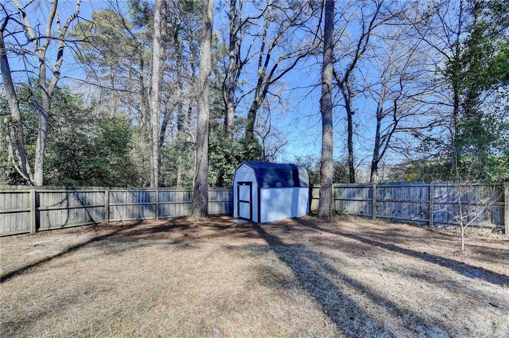 3463 Northlake Way Atlanta, GA 30340 - Photo 59 of 73 a view of a backyard with large tree and wooden fence