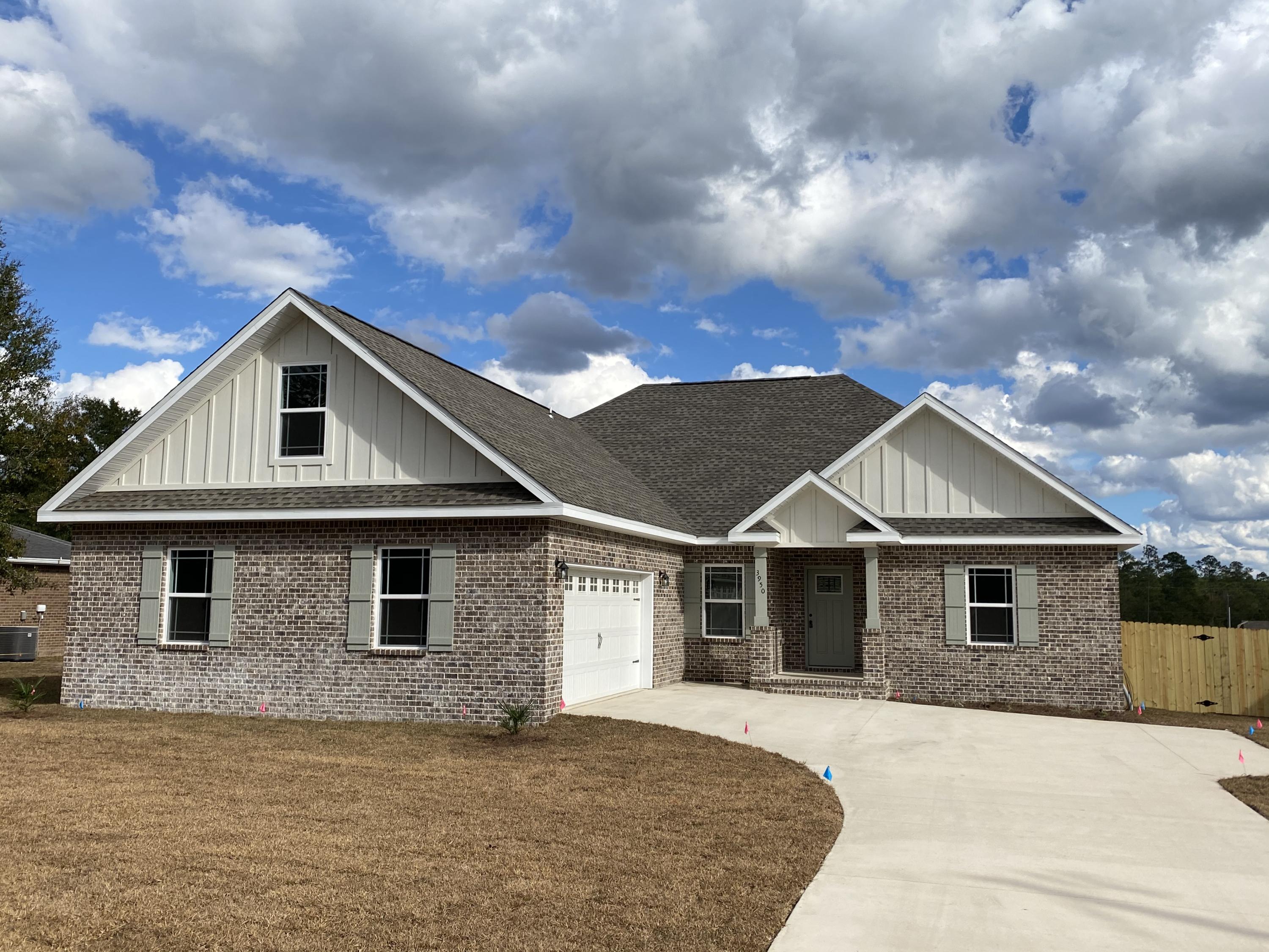 3950 Painter Branch Road Crestview, FL 32539 - Photo 1 of 18 a front view of a house with a garden
