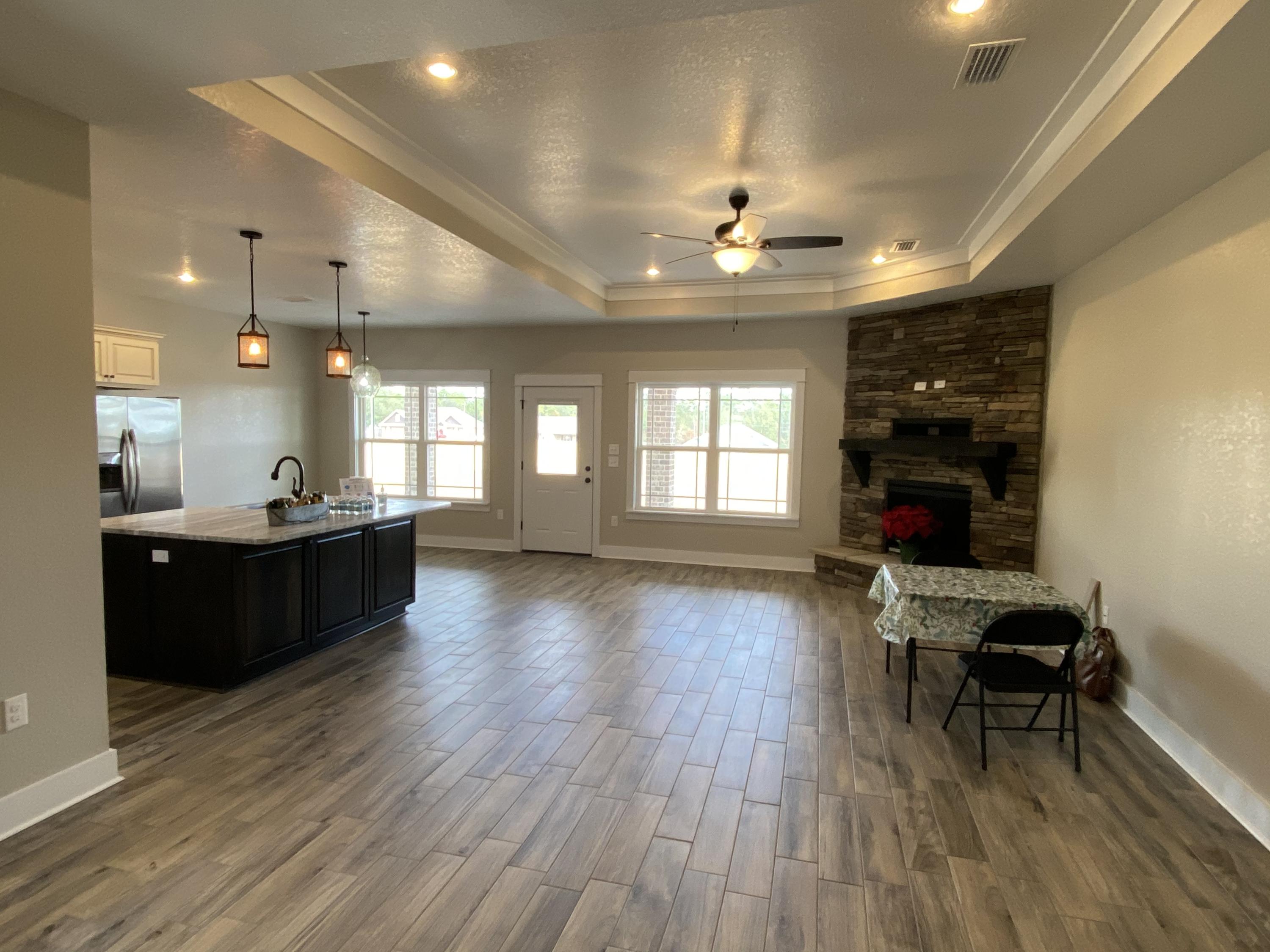 3950 Painter Branch Road Crestview, FL 32539 - Photo 5 of 18 a large room with wooden floor and windows