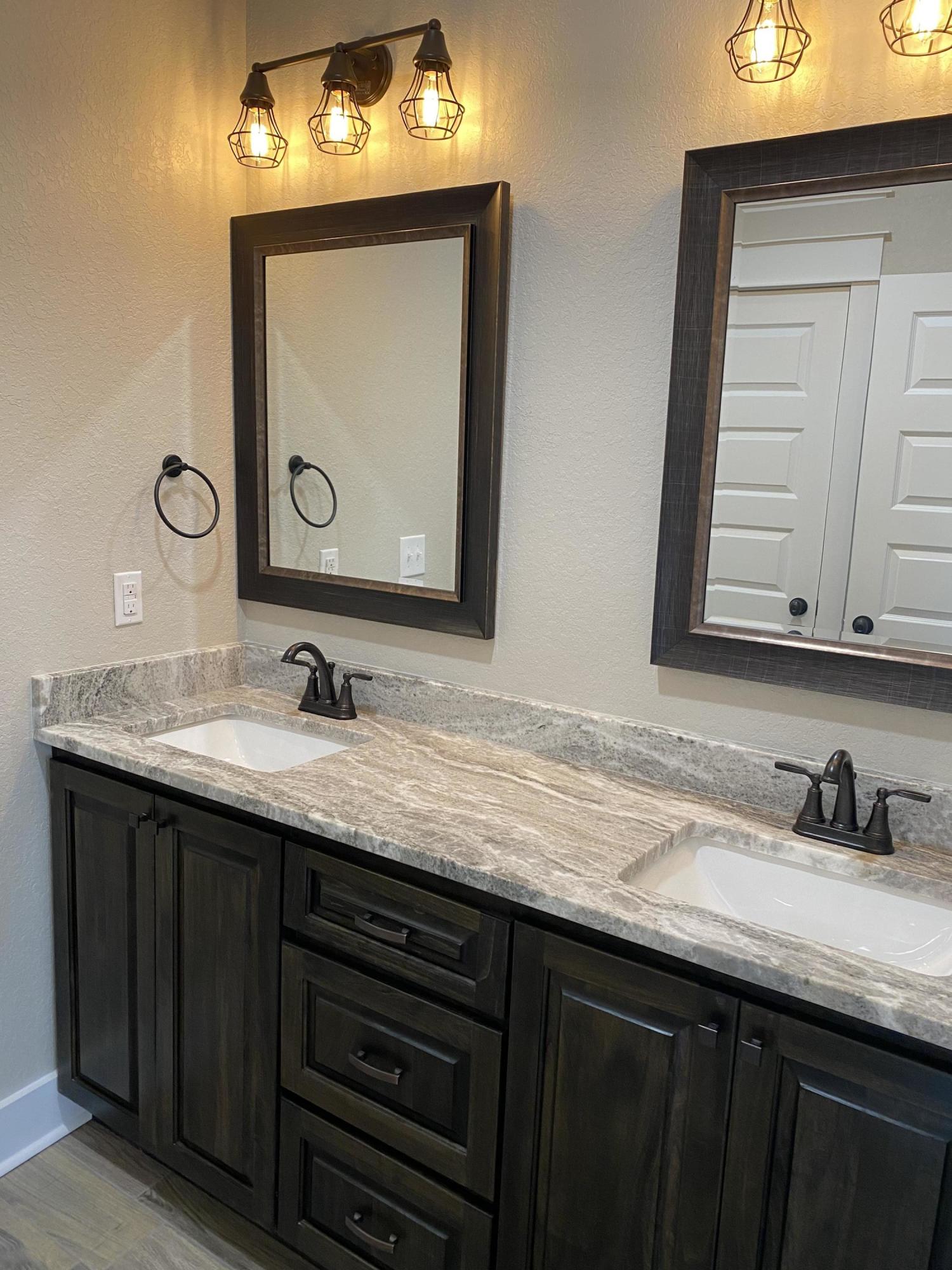3950 Painter Branch Road Crestview, FL 32539 - Photo 10 of 18 a bathroom with a sink vanity and a mirror