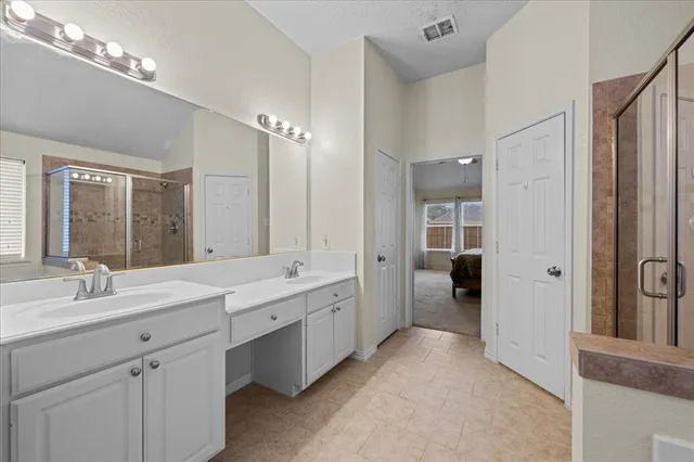a spacious bathroom with a double vanity sink mirror and double