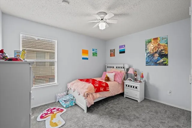 a bedroom with bed and a chandelier
