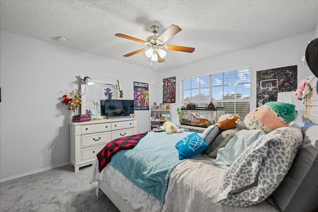 a bed room with bed and a window