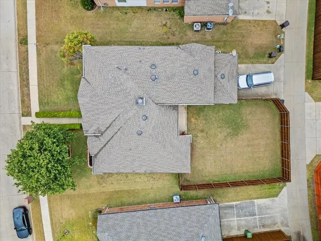 an aerial view of a house with a yard