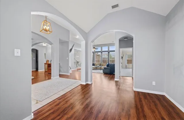 a view of a living room and kitchen with wooden floor
