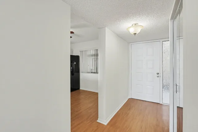a view of hallway with wooden floor