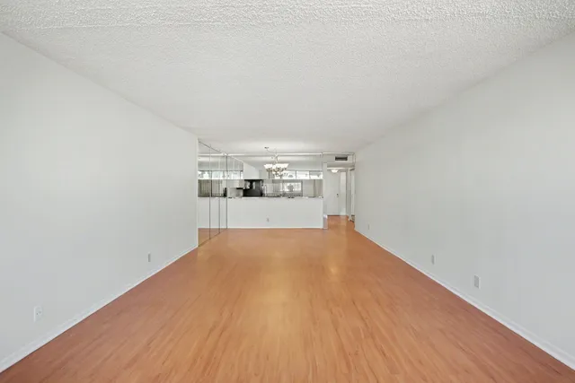 a view of a room with wooden floor