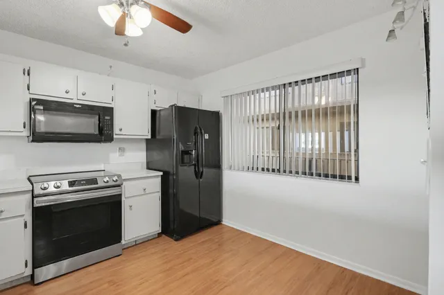 a kitchen with stainless steel appliances a stove a sink and a refrigerator