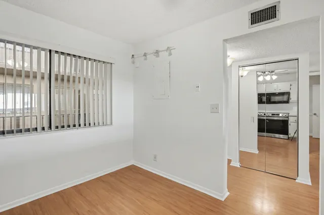 a view of a kitchen with wooden floor and a kitchen